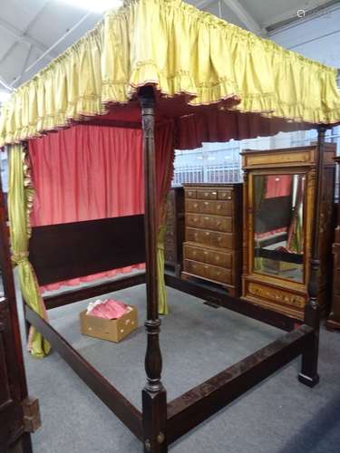 A mahogany four poster bed, the pleated canopy over reeded footend columns,