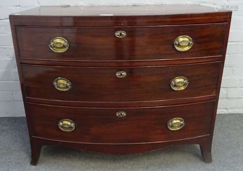 A Regency mahogany bowfront chest of three long graduated drawers on splayed bracket feet,