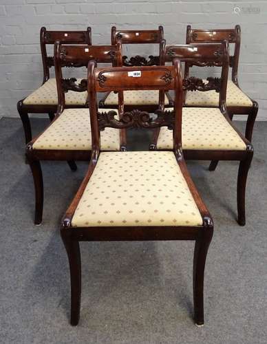 A set of six George III mahogany dining chairs, with carved waist rails on sabre supports,