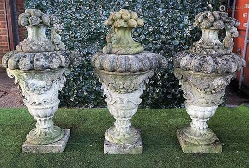 A set of three Vicenza stone sectional finials formed as fruiting jardinieres,