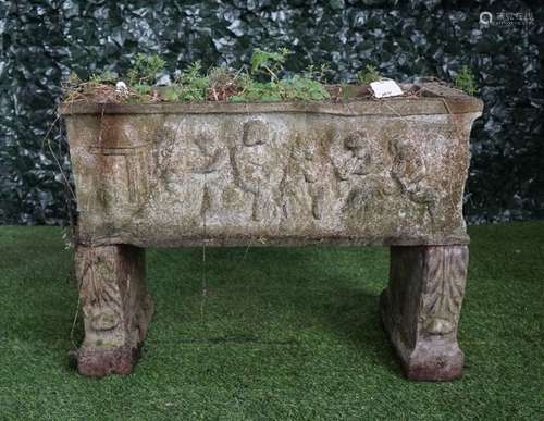 A reconstituted stone rectangular planter relief cast with cherubs resting on a pair of scroll