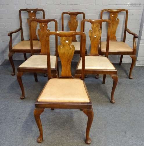 A set of twelve mid-20th century walnut vase back dining chairs on pad feet to include a pair of