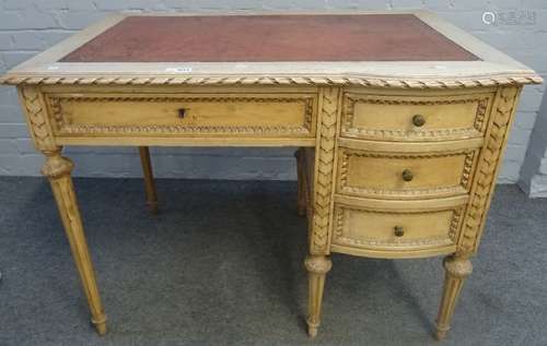 An early 20th century carved and painted beech writing desk of Louis XVI design with four frieze