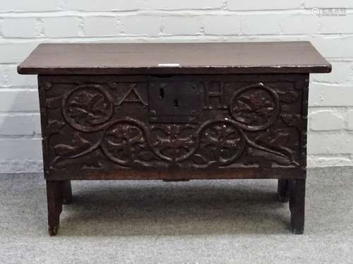 A small 17th century oak plank coffer, the carved front panel detailed A.