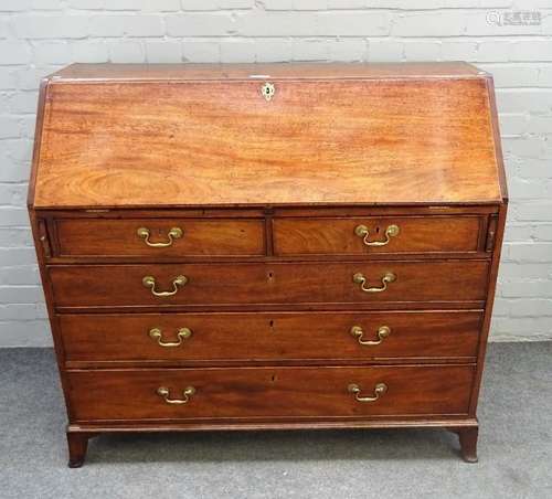 A George III mahogany bureau, the fitted interior over two short and two long graduated drawers,