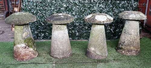 A set of four staddle stones with tapering conical bodies and mushroom tops, each approx 70cm high,