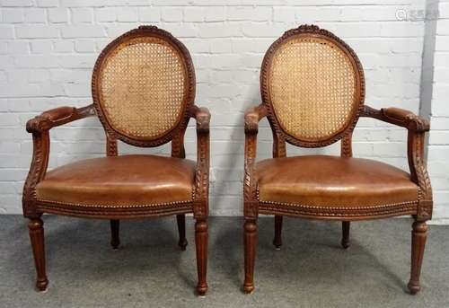 A pair of Louis XVI style brown leather upholstered carved beech framed open armchairs,