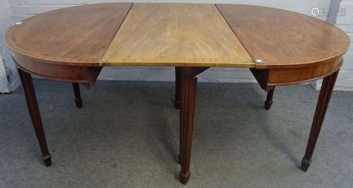 A George III mahogany 'D' end dining table, the cross banded top on channelled tapering supports,