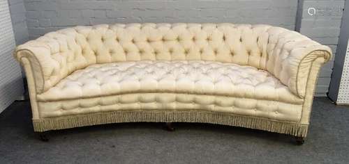 A late 19th / early 20th century faux silk upholstered concave Chesterfield style sofa on square