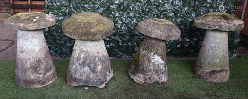 A set of four staddle stones with tapering conical bodies and mushroom tops, each approx 70cm high,