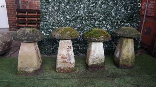 A set of four staddle stones with tapering square bodies and mushroom tops, each approx 70cm high,