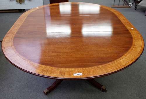 Possibly Brights of Nettlebed, a George III style satinwood banded circular extending dining table,