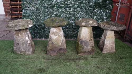 A set of four staddle stones with tapering square bodies and mushroom tops, each approx 70cm high,