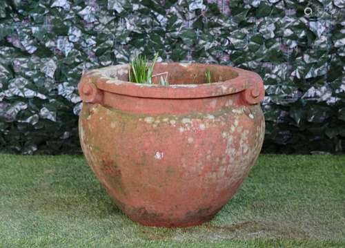 After a design by Gertrude Jekyll, a terracotta Compton Pottery style scroll handle Celtic pot,