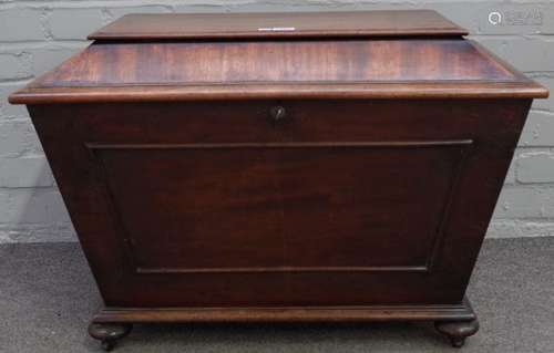 A Regency mahogany sarcophagus shaped cellarette, with moulded panel front on bun feet,