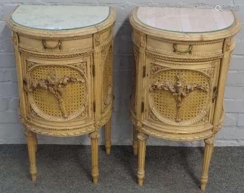 A pair of Louis XVI style carved beech and cane work demi-lune bedside tables,