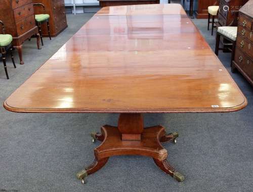 A William IV mahogany triple pedestal extending dining table on three square baluster columns and