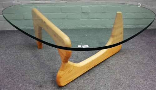 A Noguchi style glass and beech coffee table, 130cm wide x 40cm high.