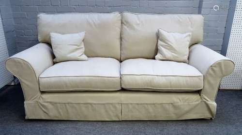 A modern three piece suite with loose cream upholstery to comprise a sofa, 207cm wide x 78cm high,