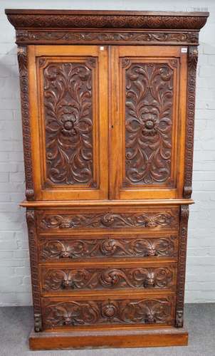 Edwards & Roberts; A 19th century carved oak bedroom suite to comprise, linen press,