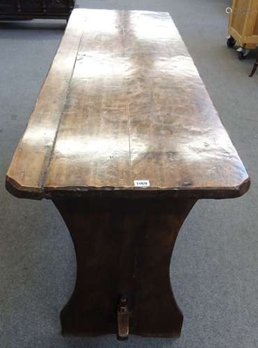 A 17th century and later fruitwood tavern table on slab end supports united by a stretcher,