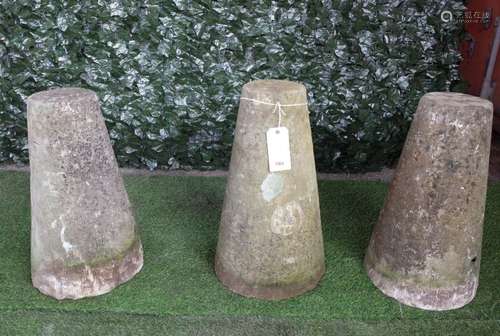 A set of three conical staddle stone bases, each 64cm high, (3).