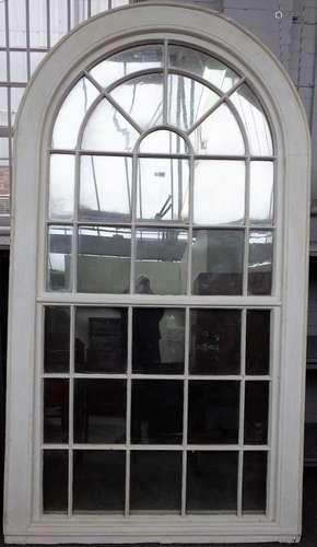 A large George III white painted arch top astragal thirty four panel window frame,