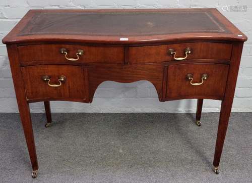 A George III style mahogany serpentine writing table with four frieze drawers on tapering square