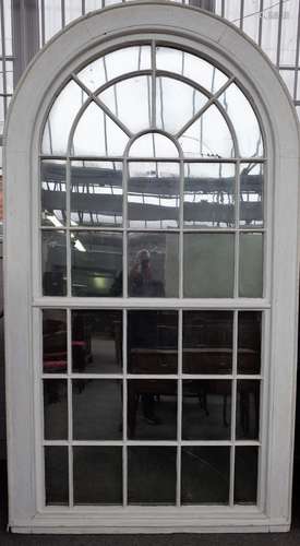 A large George III white painted arch top astragal thirty four panel window frame,