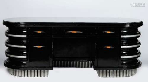 An Art Deco ebonised and silvered wood banded office desk, with rounded ends,