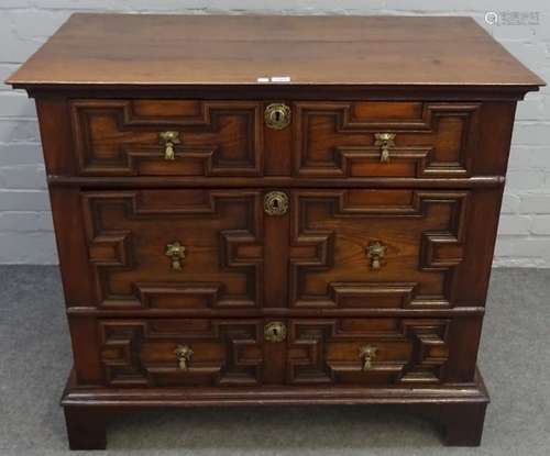 A Charles II oak chest of three long graduated geometric moulded drawers on bracket feet,