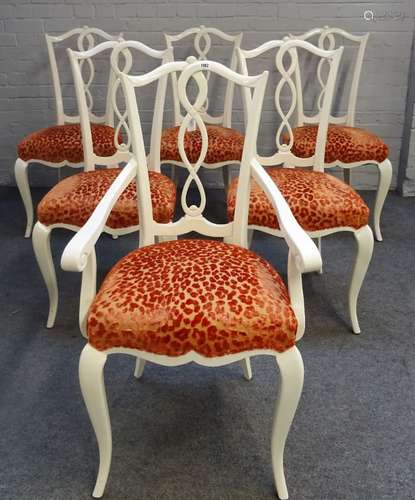 A set of twelve glossy white finish dining chairs, with pierced splats,