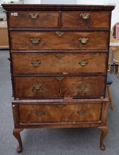 A George I figured walnut chest on stand with two short over three long graduated drawers,