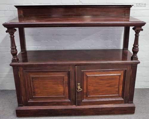 JAS Shoolbred & Co; a mahogany buffet with two open tiers over pair of panelled cupboards,