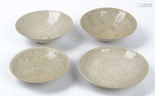 Three Chinese qingbai bowls, probably Song dynasty, each carved with foliate scrolls, 16cm to 17.