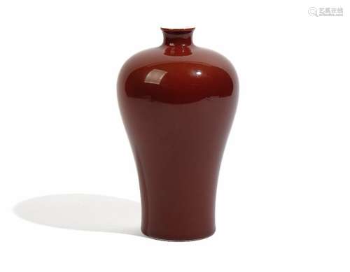 A Chinese flambé glazed porcelain vase, of slender baluster form covered in a deep red glaze, 20.