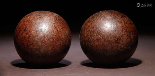 PAIR OF CHENXIANG WOOD CARVED HAND BALL