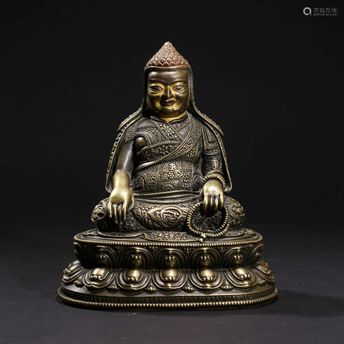 A BRONZE GURU STATUE