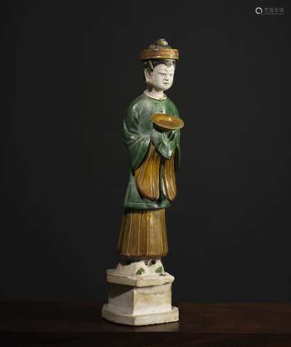 侍者中国明代(1348-1643)绿、黄、黑釉陶器。高45厘米，她的面前有一个盘子。来源：中国和印度公司(巴黎)(Inv.23819 2006年获得)