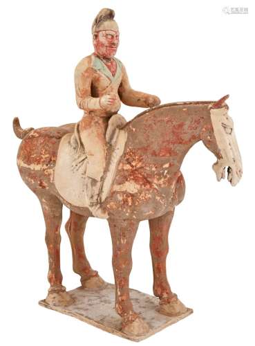 A Chinese Polychrome Decorated Pottery Figure of a Horse and Rider