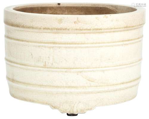 A Chinese Cream Glazed Earthenware Tripod Censer