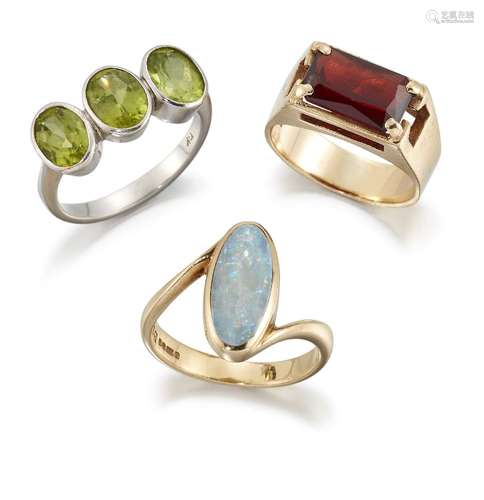 Three gem rings, comprising: an oval peridot three stone; an oval opal single stone in 9ct gold