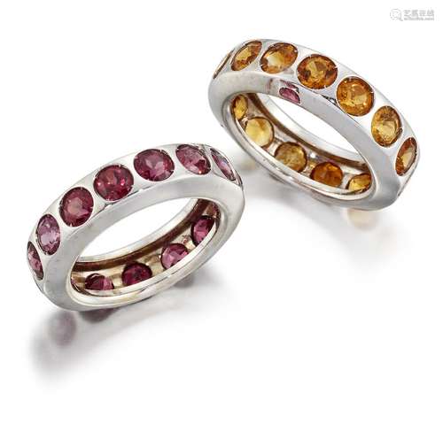 A pair of gem eternity rings, set with either a line of circular-cut citrines or circular-cut pink