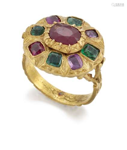 A ruby and diamond ring, of oval cluster design, the central oval ruby to a surround of alternate