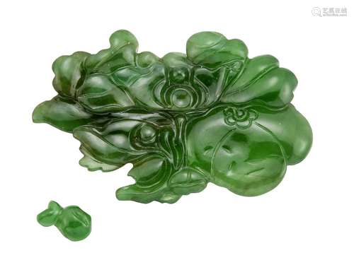 An unmounted carved jadeite jade plaque, of flowerhead and foliage design, weighing approximately