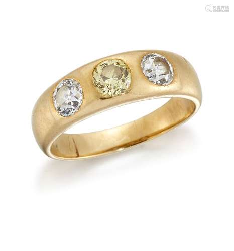 A pale yellow diamond and diamond three stone ring, in gypsy mount, the central pale yellow old-