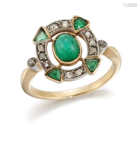 An early 20th century emerald and diamond ring, the central oval cabochon emerald collet to an old-