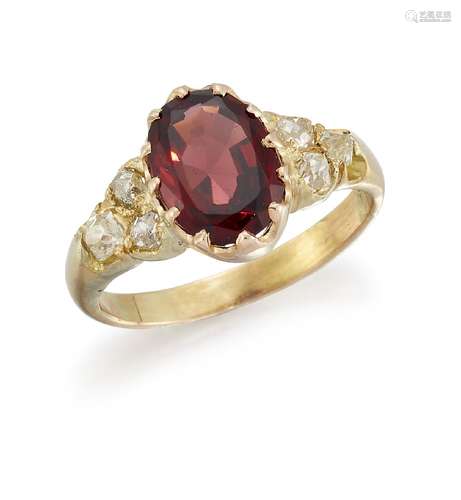 A garnet and diamond ring, the central oval garnet to old-cut diamond three stone shoulders, ring