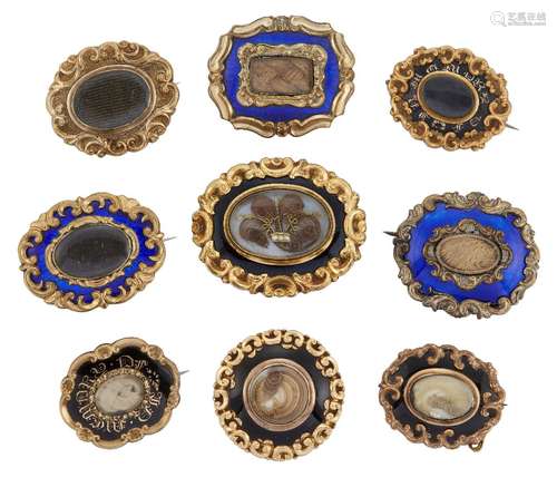 A group of nine 19th century gilt-mounted mourning brooches, comprising: five black enamel examples,