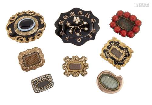 A group of eight 19th century gilt-mounted mourning brooches, comprising: three enamel examples, one